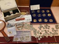 Overview of all boxed sets, loose coins, commemorative packs, coin roll, magnifier