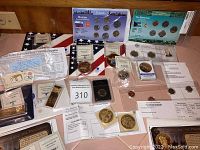 Overview of all items including world coin sets, ingots, medallions, certificates and a collector card