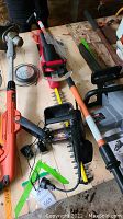 Overhead view of multiple power tool components on wooden table
