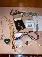 Overview of all jewelry pieces and loose stones laid out