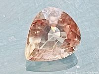 Pear-shaped padparadscha sapphire showing color and faceting
