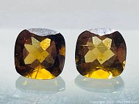 Front view of the two cushion cut Madeira citrines showing their matched color, cut, and clarity.