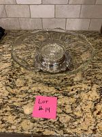 Top-down view of the cut glass bowl showing decorative cut patterns and scalloped edge with silver plate base underneath.