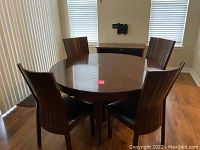 Round table and four chairs in dining area, view from angle