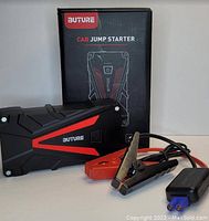 Buture branded car jump starter device, jumper cables with clamps and original product box shown on a white background.