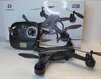 Photo of Deerc D50 drone and its remote controller with product box in background.