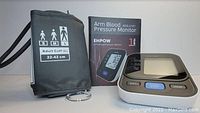 Photo showing digital arm blood pressure monitor, adult large cuff, and product box