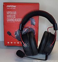 MPOW Air Wireless Gaming Headset in black and red, displayed in front of its original red box with product name and features visible.