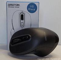 Black Omoton wireless mouse shown with packaging box labeled 'US Black'. Mouse has ergonomic shape with side buttons and scroll wheel visible.