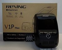 Photo of Rexing V1P Max dash camera device next to its product box showing specifications like 3840x2160 front camera, 1920x1080 rear camera, built-in WiFi, and GPS logger.
