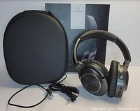 Photo showing Vankyo C750 wireless headset, carrying case, USB charging cable, and original box.