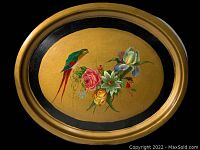 Front view of the oval tray showing the entire hand-painted design with parrot and flowers inside gold and black borders.
