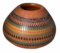 Side angle view showing the intricate geometric painted designs and textured upper section of the Navajo vase.