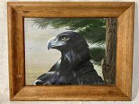 Front view of oil painting of a crow signed by Vi Fabik, depicting the bird against pine branches with a wooden frame