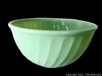 Side view of the 9 inch diameter mixing bowl showing the swirl fluted pattern and wide rim.