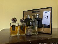 Lot showing two bottles of Royalty perfume with decorative silver crowns, a small Old Spice bottle, Ligo aftershave, with boxed Polo Blue set behind