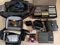 Overview of lot contents including camcorders, carrying cases, tapes, and accessories