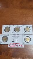 Five Canadian two dollar coins displayed on MaxSold card, front view showing all coins.