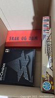 Box with Sequence, Skak og Dam, and Tri-Ominos board games visible