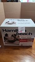 Box of Hamilton Beach meat slicer showing brand and product image, indicating it is a meat slicer.