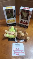 Photo of two boxed Star Wars action figures and two plush toys with MaxSold label.