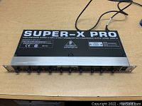 Top view of the Behringer Super-X Pro CX2310 crossover showing model and branding on the chassis.