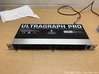 Front angled view of the Behringer Ultragraph Pro 15-band equalizer showing top label and unit body.