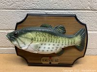 Front view of Big Mouth Billy Bass mounted on wooden plaque with the label visible.