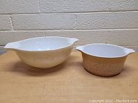 Both vintage Pyrex bowls displayed side by side showing size and design differences