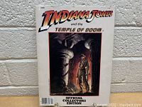 Photo of front cover of vintage Indiana Jones and the Temple of Doom Official Collectors Edition book.