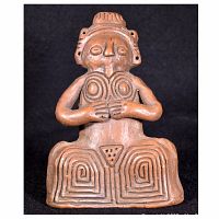 Front view of solid pottery female fertility totem showing detailed facial features, hands holding breasts and geometric patterns on front of figure's legs and abdomen.