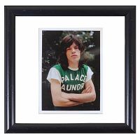 Front of framed color photograph showing Mick Jagger wearing a green Palace Laundry shirt with arms crossed.