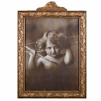 Front view of the original 1897 photograph print titled "Cupid Awake" by Morris Burke Parkinson showing a cherubic child with angel wings, in the original ornate carved wooden frame with handmade glass.