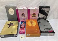 Overview of 8 Mattel Barbie dolls in their original boxes showing a variety of collectible editions including Christian Dior and Silver Screen Barbie.
