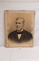 Front view of the antique gentleman portrait print showing the man in formal attire with some discoloration and damage around edges.