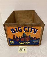 Front view of wooden fruit crate box showing Big City Suisun Bartletts label with city skyline graphic