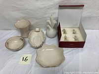 Lot of 5 ceramic decorative items including two vases, 2 bowls, and an oval serving dish, all light cream or white with some gold trim and detail.