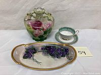 Image showing the full lot with ewer, floral tray, tea cup, and saucer arranged together on a table