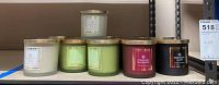 Front view of assortment of seven candles, various scents and colors visible