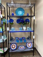 Front view of black metal shelving unit with display items on shelves showing size and structure