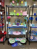 Photo showing the black metal shelving unit filled with decorative items for display purpose only. Shelving dimensions and structure are visible.