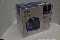 Sealed cardboard box of Hyundai HY2200P 2200W inverter generator showing front panel and branding