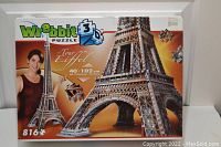 Front-facing image of the Wrebbit 3D Eiffel Tower puzzle box showing the product details and the model size and number of pieces.