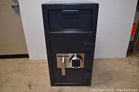 Front view of closed safe showing deposit hopper, electronic keypad and handle