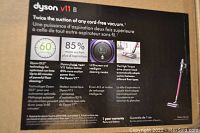 Box front showing Dyson V11 B features including 60-minute runtime, 85% more suction, LCD screen, and high-torque motorized head
