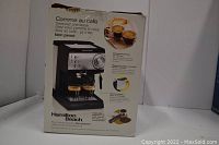 Photo of original packaging box showing espresso maker image and French text description