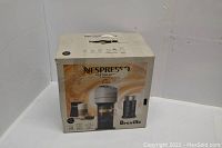 Full view of original box packaging of Nespresso Vertuo Next Premium coffee and espresso machine with Aeroccino3 milk frother bundle.