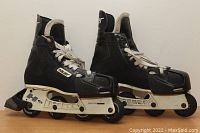 Side view of the black Bauer H3 size 10 roller hockey skates on wheels, showing laces, frame, and wheels.