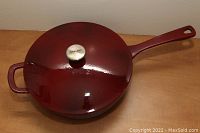 Angled top view showing entire frying pan with lid, highlighting the exterior color and pan handles.