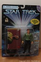 Full front view of the Star Trek Captain Kirk action figure package showing the figure, collector card, and packaging condition.